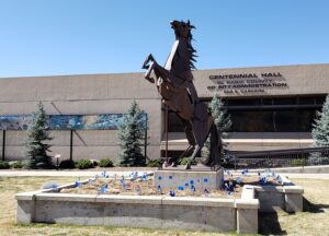 Image of El Paso County DHS staff planted blue pinwheels and flags in front of Centennial Hall in downtown Colorado Springs and at Citizens Service Center for the month of April.