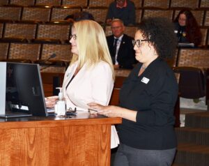Stacie Kwitek (left), El Paso County Department of Human Services executive director, speaks at the podium with Catania Jones, director of Children, Youth and Family Services in DHS, about foster care during the regular meeting of the Board of El Paso County Commissioners on Tuesday, May 24, 2022.