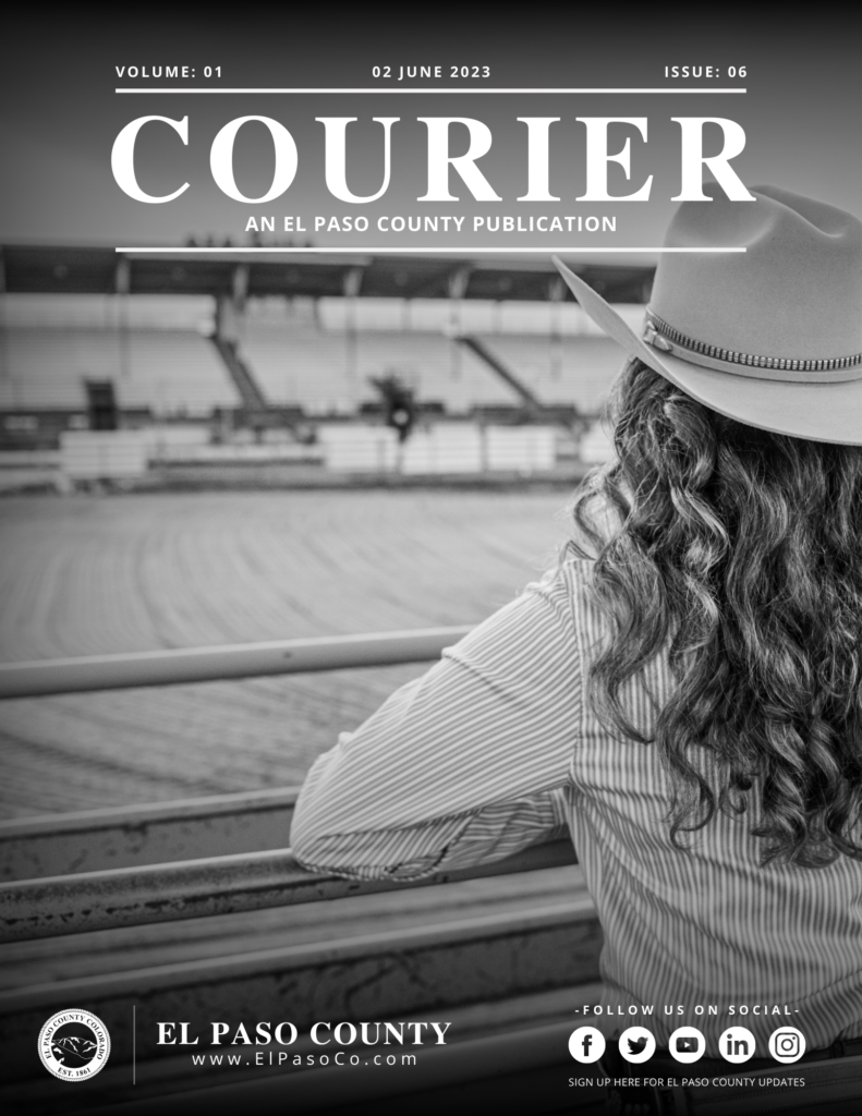 Image of the front cover of The Courier Newsletter for April 2023. Black background, white text: "COURIER" with the Fair Queen looking on at an empty arena and grandstands.