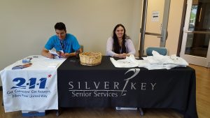 Silver Key Senior Services staff work at a table of resources during a day of workshops for World Elder Abuse Awareness Day on June 15.