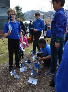 Children plant pinwheels at the Colorado Springs Conservatory on Monday, April 1, 2019. April is national Child Abuse Prevention Month.
